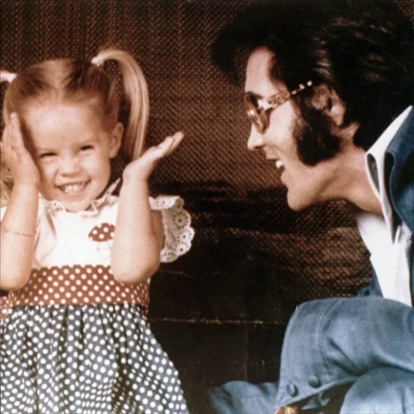 Elvis with young Lisa Marie at Graceland